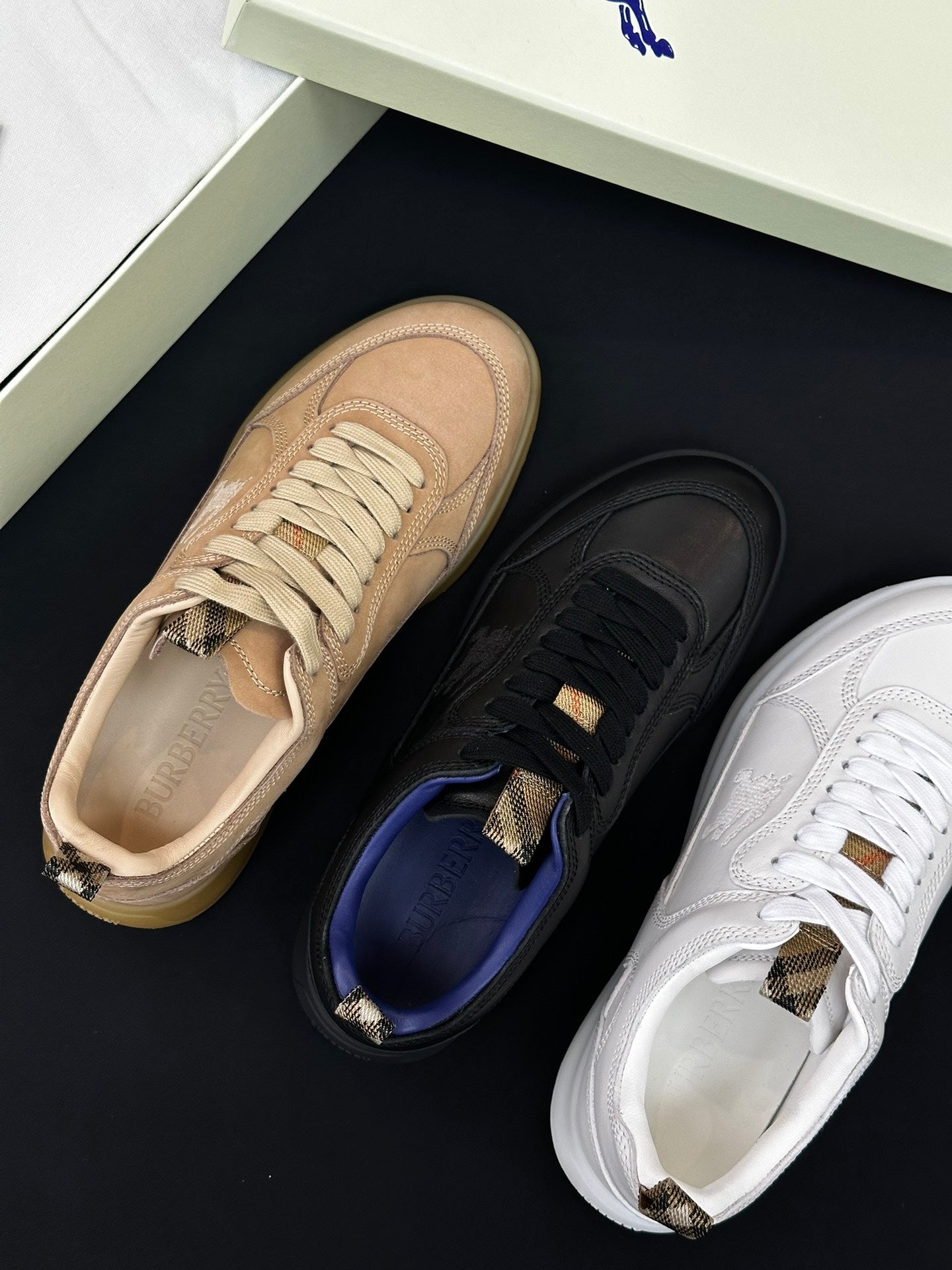 Burberry shoes close-up: beige, black, and white sneakers with lace-up details