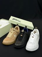 Burberry shoes with tan, black, and white sneakers with lace-up fronts