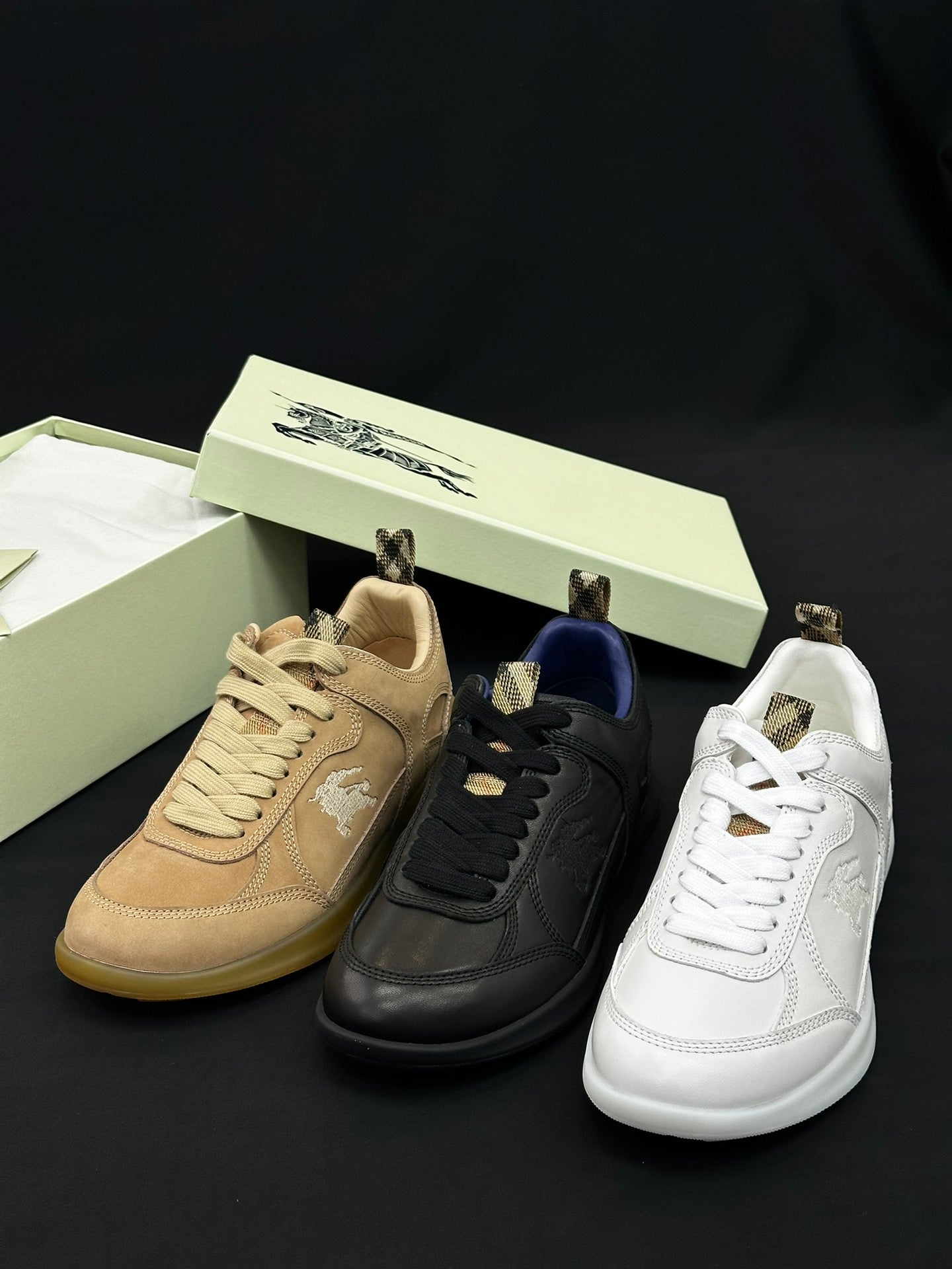 Burberry shoes with tan, black, and white sneakers with lace-up fronts