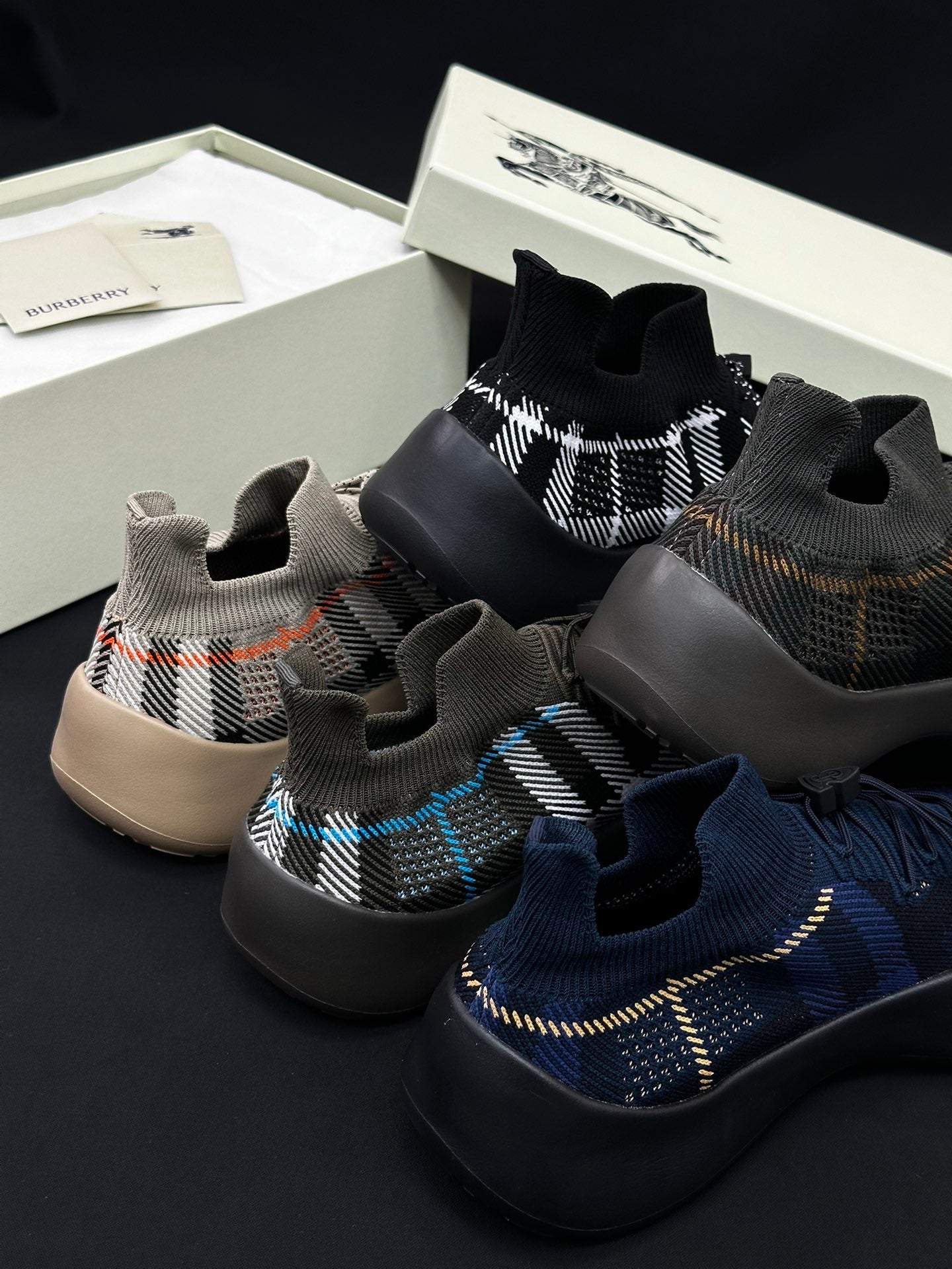 Burberry knit sneakers with elastic ankle openings, black plaid and blue trim