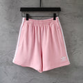 Pink Balenciaga track shorts with elastic waistband and side stripe accents