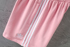 Pink Balenciaga track shorts with white triple side stripes and small emblem
