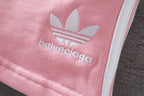 Pink fabric with white Balenciaga trefoil logo print and adidas-style emblem