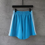 Balenciaga blue shorts with white side stripes and elastic waistband