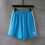 Balenciaga blue shorts with white side stripes, elastic waistband and side pockets