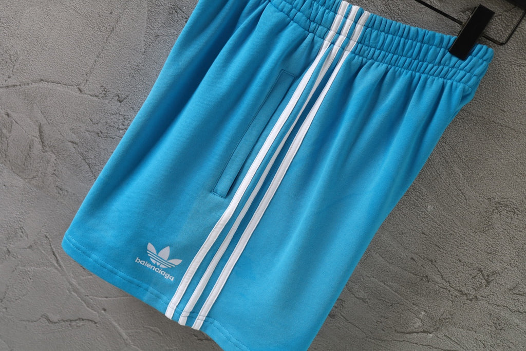 Balenciaga blue shorts with white side stripes and elastic waistband