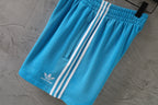Balenciaga blue shorts with white side stripes and elastic waistband