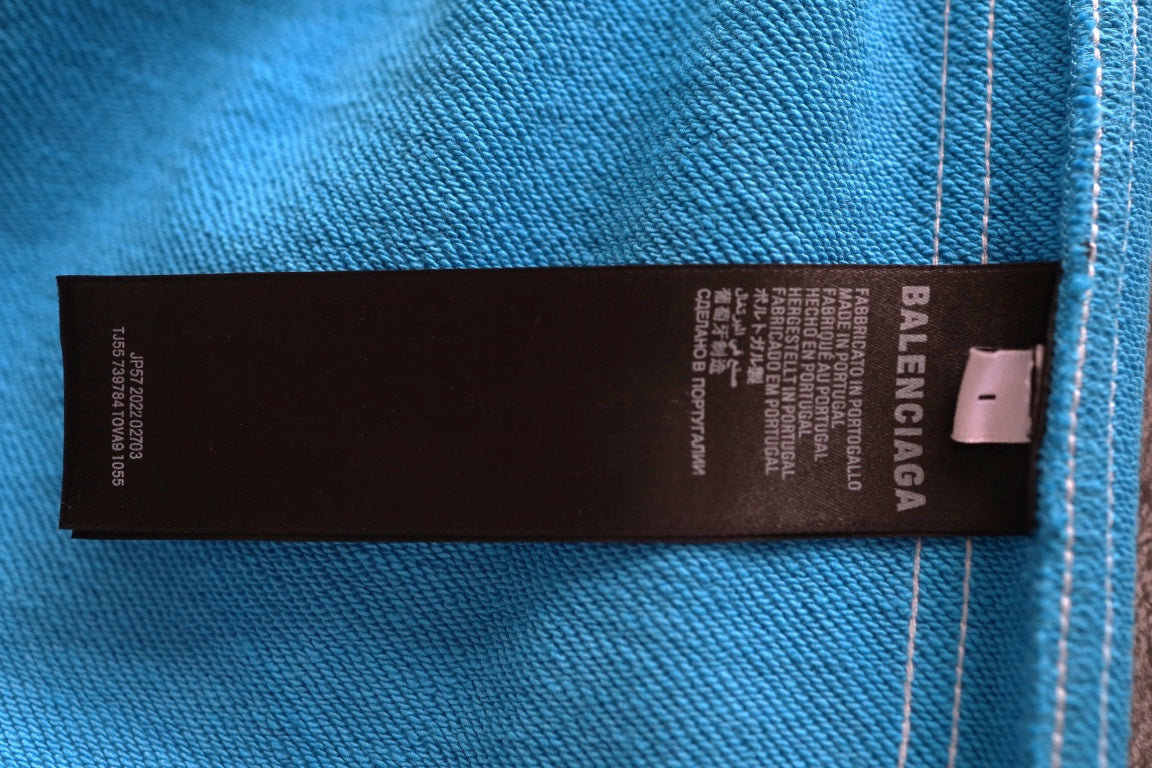 Balenciaga blue shorts fabric label tag with care text and brand mark