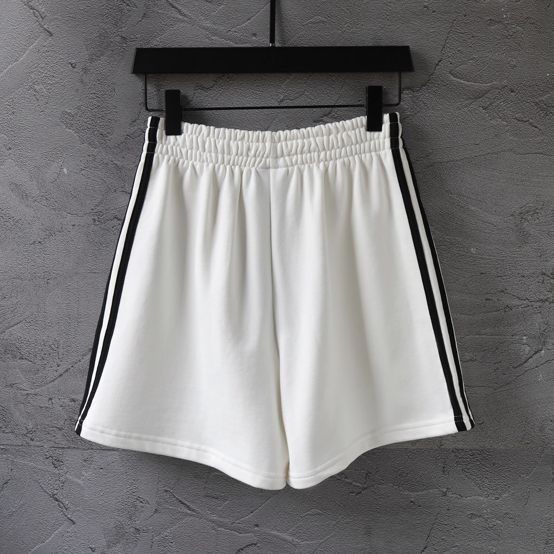 White Balenciaga shorts with black side piping and gathered elastic waist
