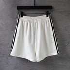 Balenciaga white shorts with black side stripes and elastic waist