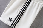 Balenciaga white shorts with black triple side stripes and logo