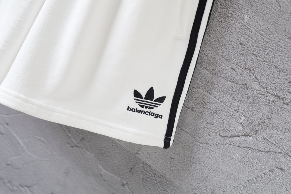 White Balenciaga shorts hem with small logo and black side stripe