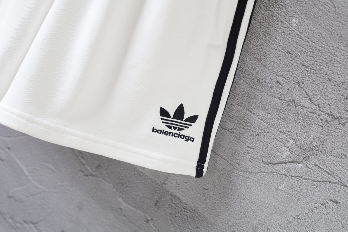 White Balenciaga shorts hem with small logo and black side stripe