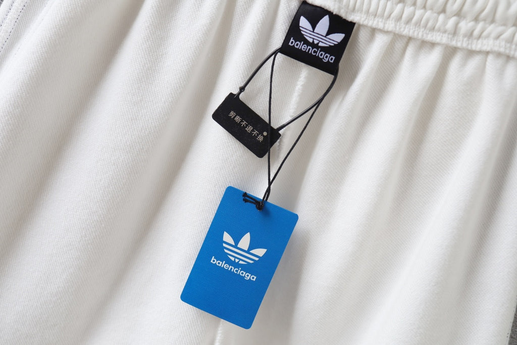 White shorts with hanging Balenciaga tags near the elastic waistband
