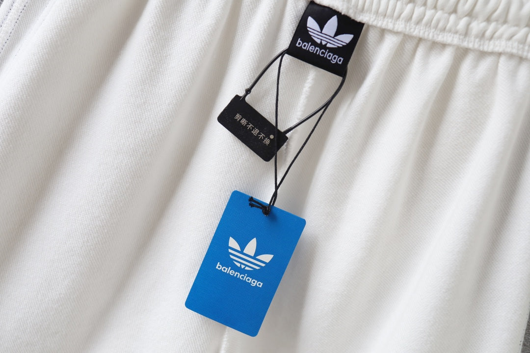 White shorts with hanging Balenciaga tags near the elastic waistband