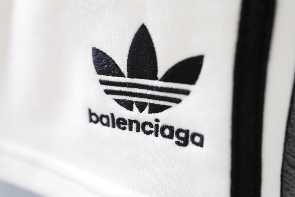Close-up of Balenciaga logo on white shorts