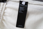 White shorts with brand label tag at the waistband