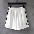 White Balenciaga shorts with elastic waistband and black side stripes