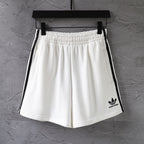 Balenciaga white shorts with elastic waistband and black side stripes