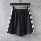 Balenciaga black shorts with elastic waistband and white triple side stripes