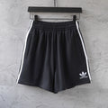 Balenciaga black shorts with white side stripes and small front logo