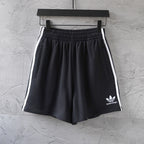 Balenciaga black shorts with white side stripes and small front logo