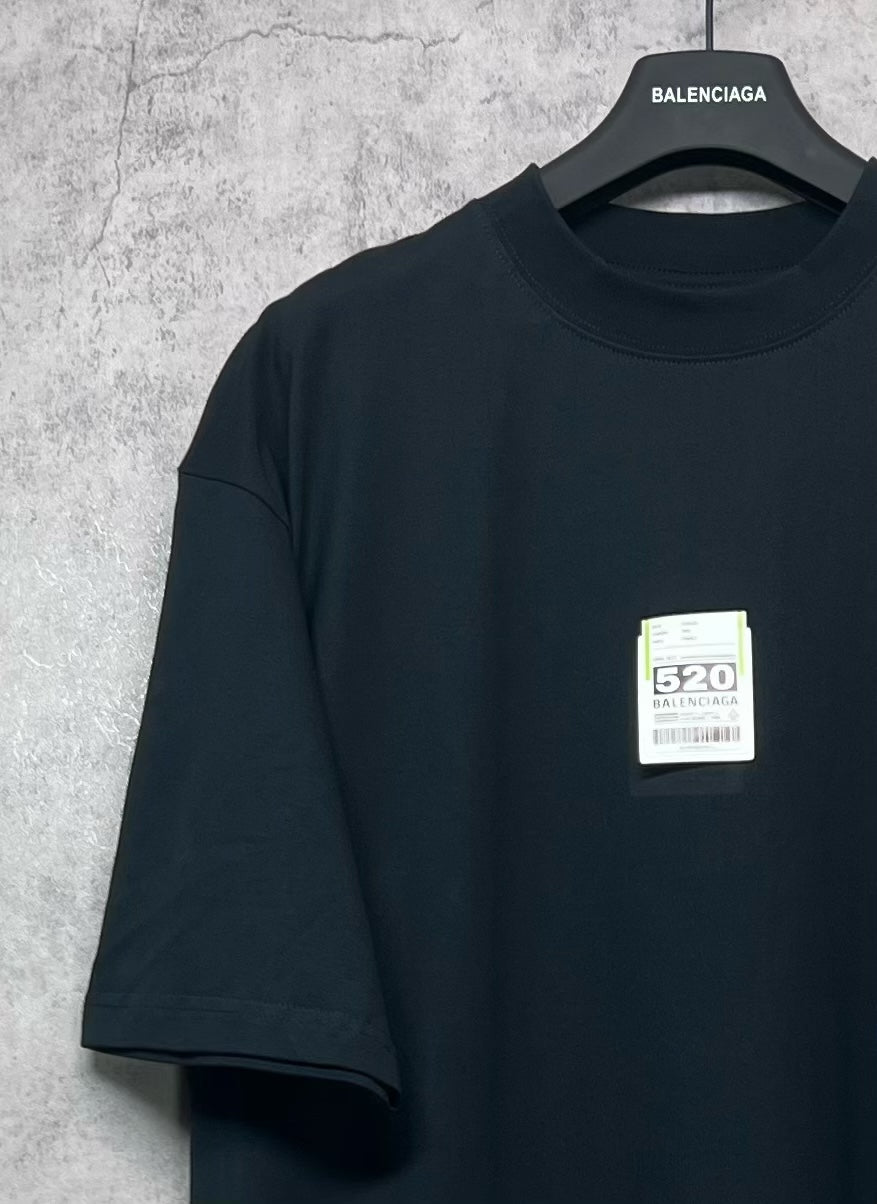 Balenciaga crew-neck short-sleeve T-shirt, dark, angled view with label 520