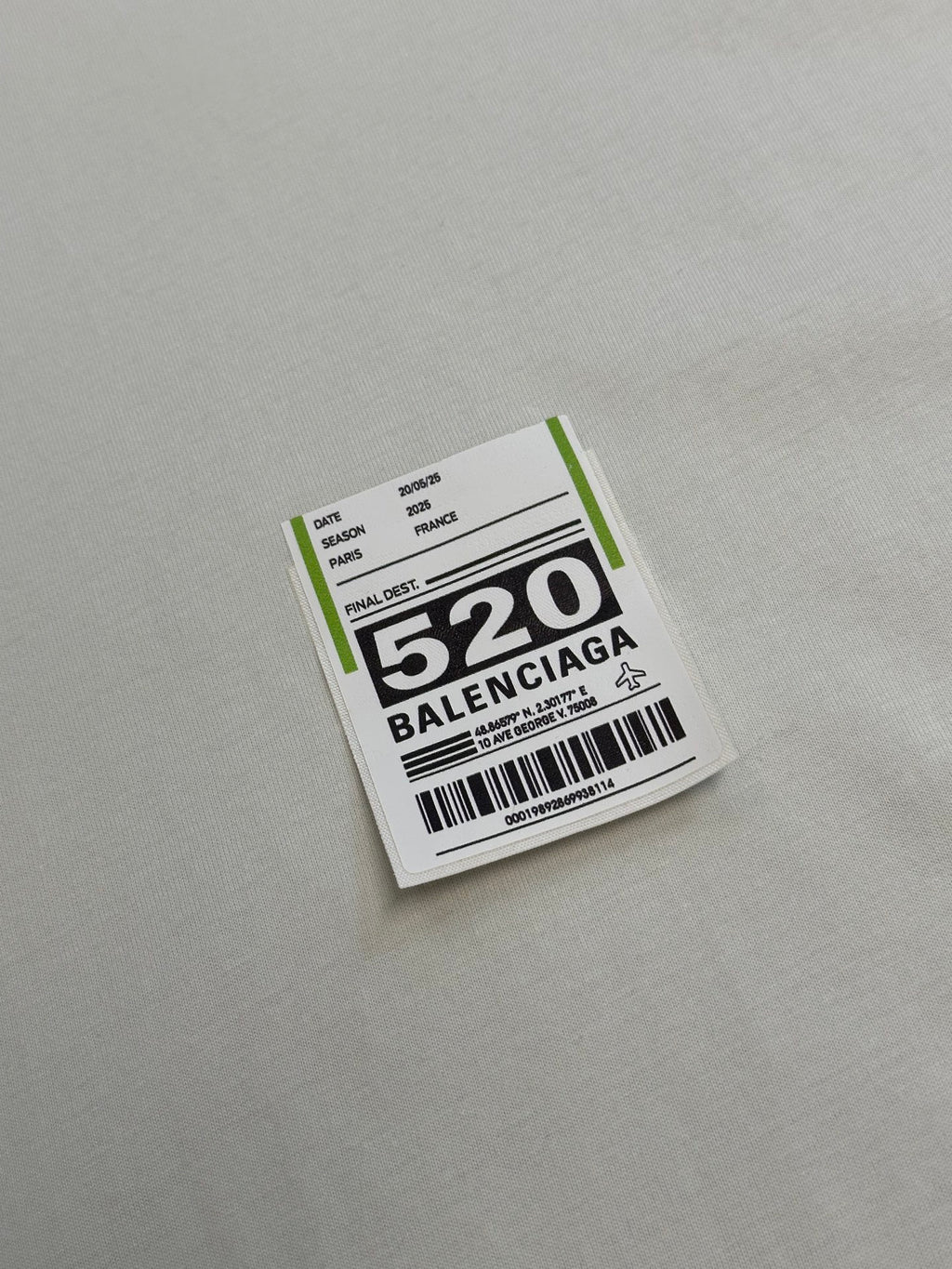 Balenciaga clothing label patch with barcode and “520” text on fabric