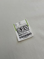 Balenciaga clothing label patch with barcode and “520” text on fabric