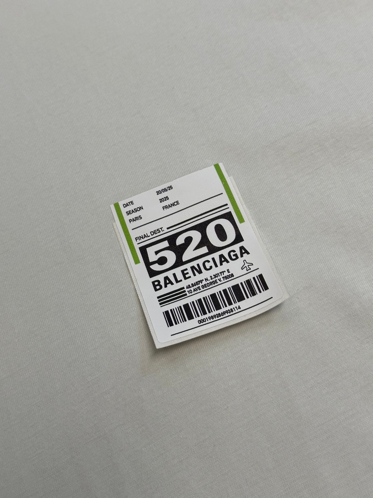 Balenciaga clothing label patch with barcode and “520” text on fabric