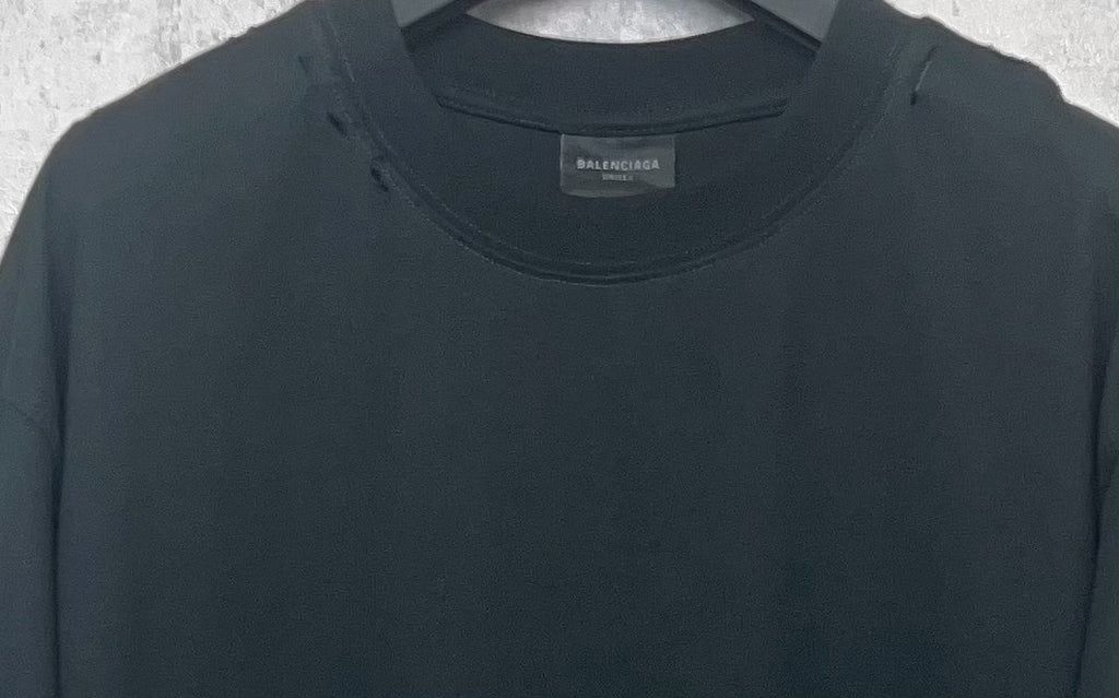 Black Balenciaga T-shirt neckline close-up with crew neck and small brand tag.