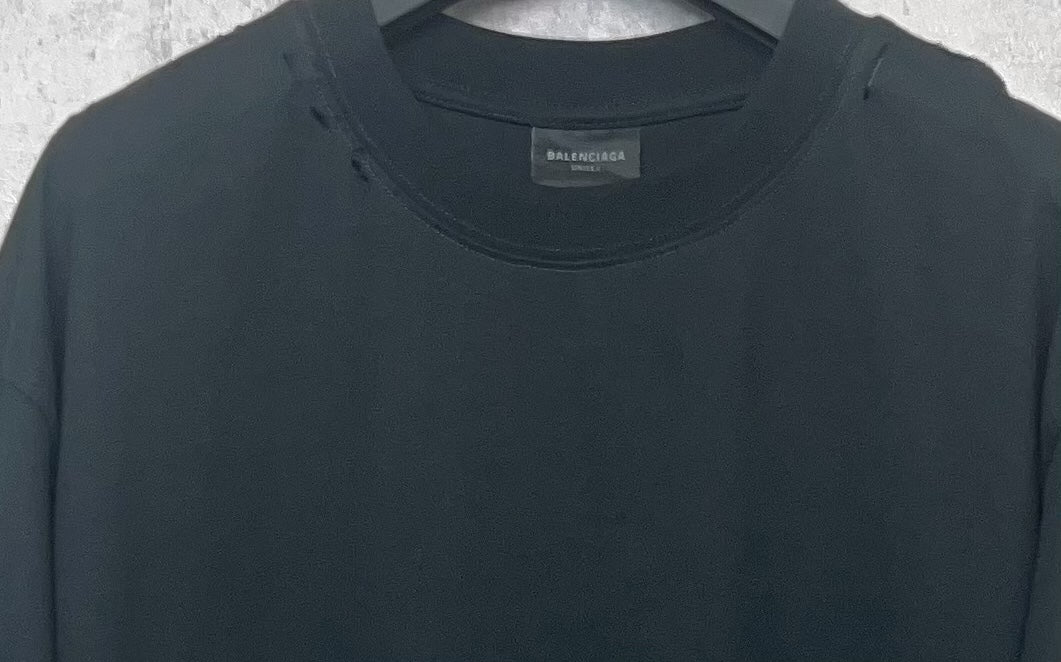 Black Balenciaga T-shirt neckline close-up with crew neck and small brand tag.