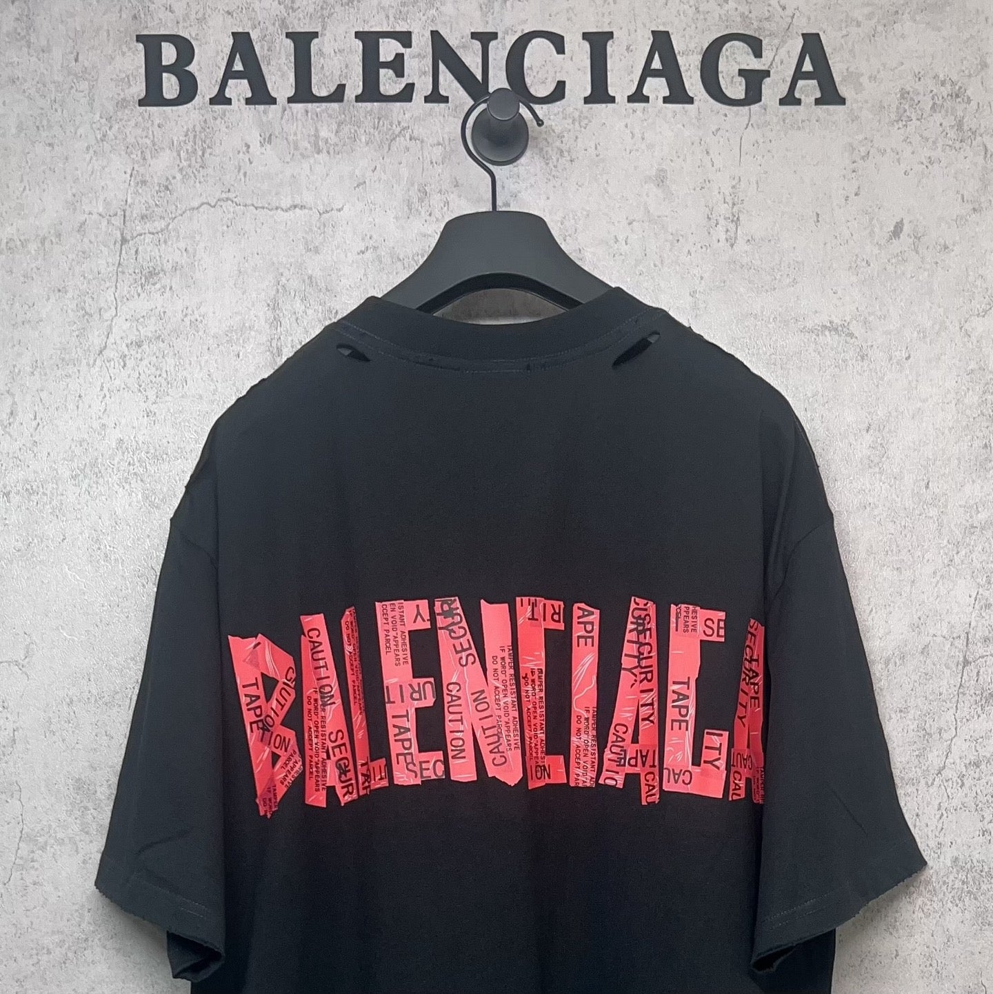 Black Balenciaga T-shirt with red back graphic logo print, short sleeves.