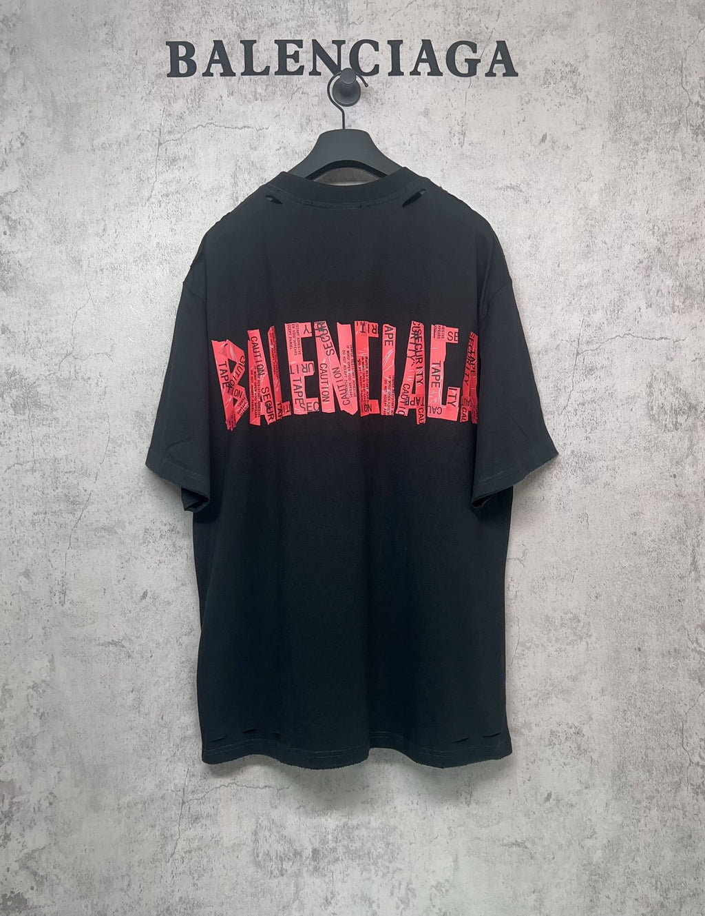 Black Balenciaga T-shirt with red graphic logo print, short sleeves, crew neck.