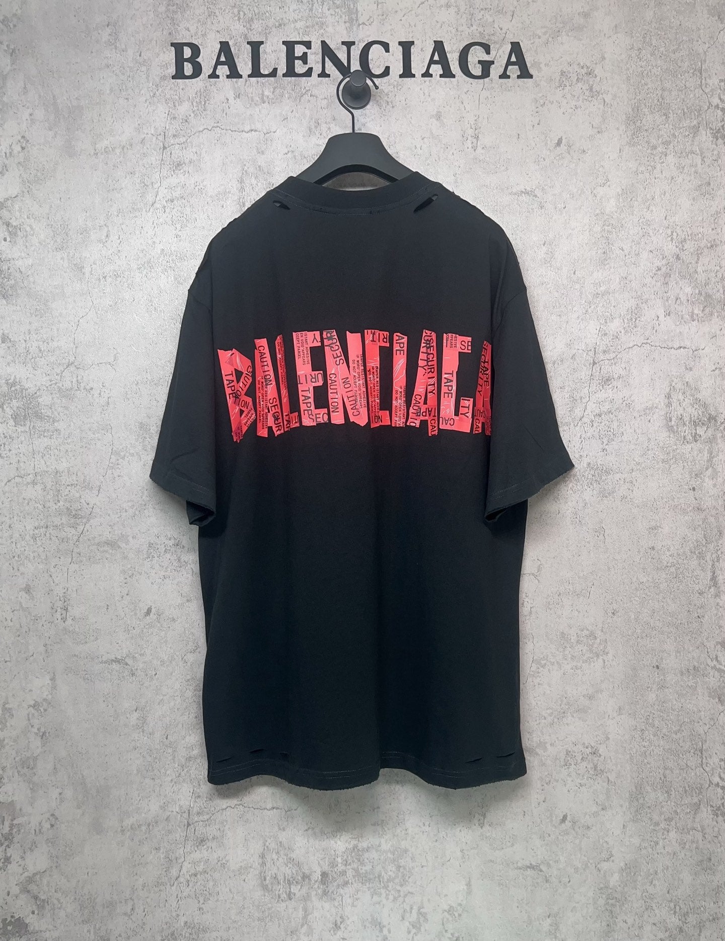 Black Balenciaga T-shirt with red graphic logo print, short sleeves, crew neck.