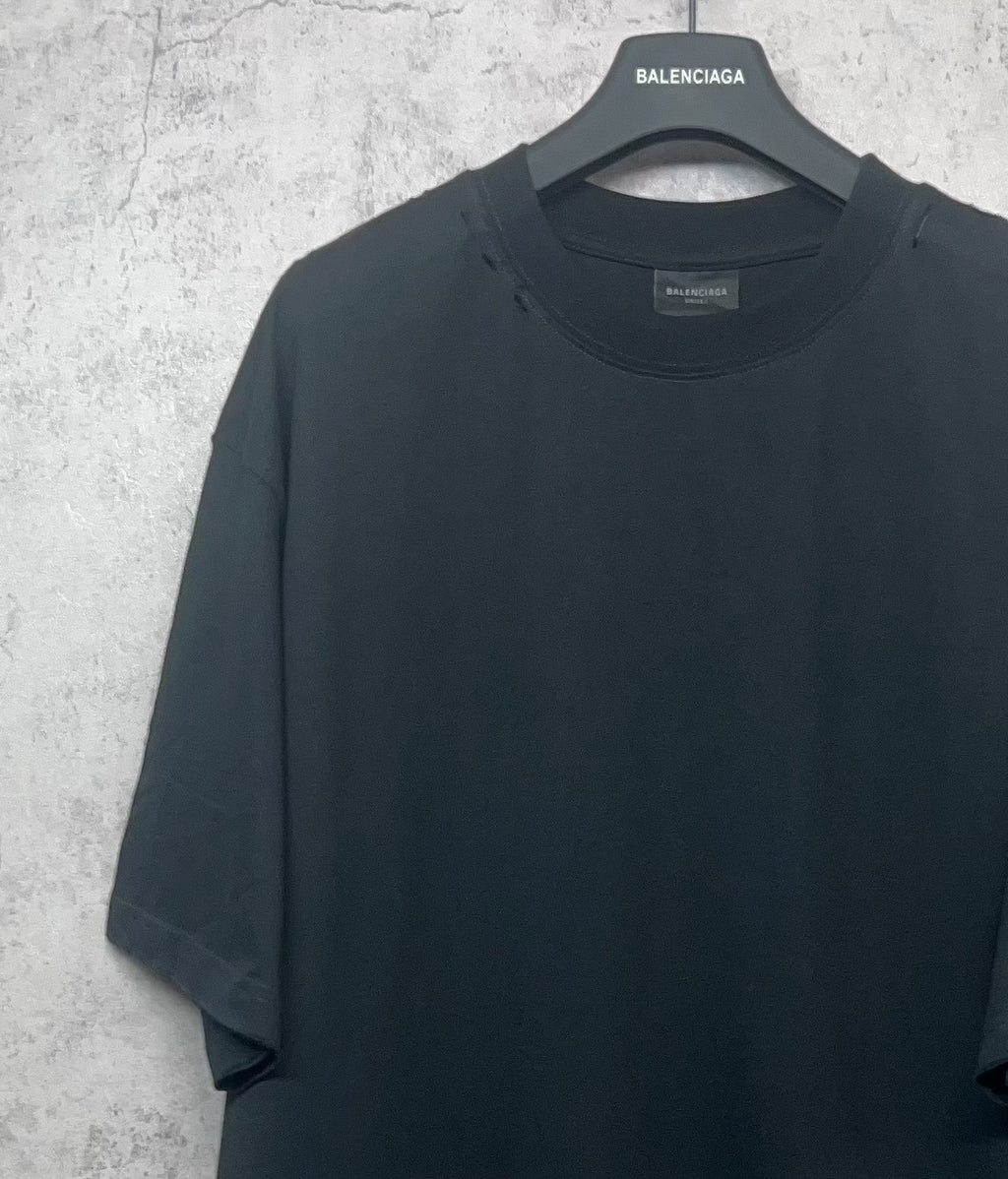 Black Balenciaga T-shirt front view on hanger, crew neck and relaxed fit.
