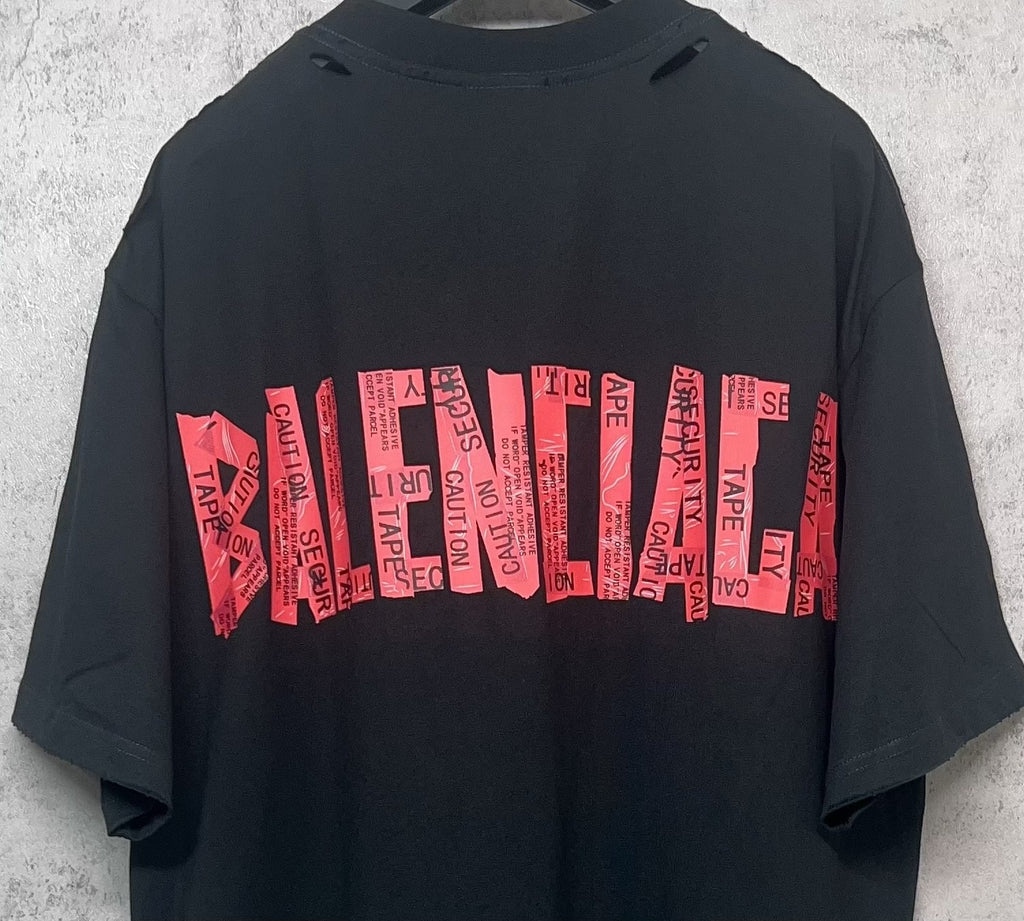 Black Balenciaga T-shirt back close-up with red graphic logo stripe text print.