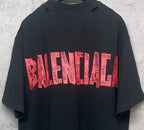 Black Balenciaga T-shirt back close-up with red graphic logo stripe text print.
