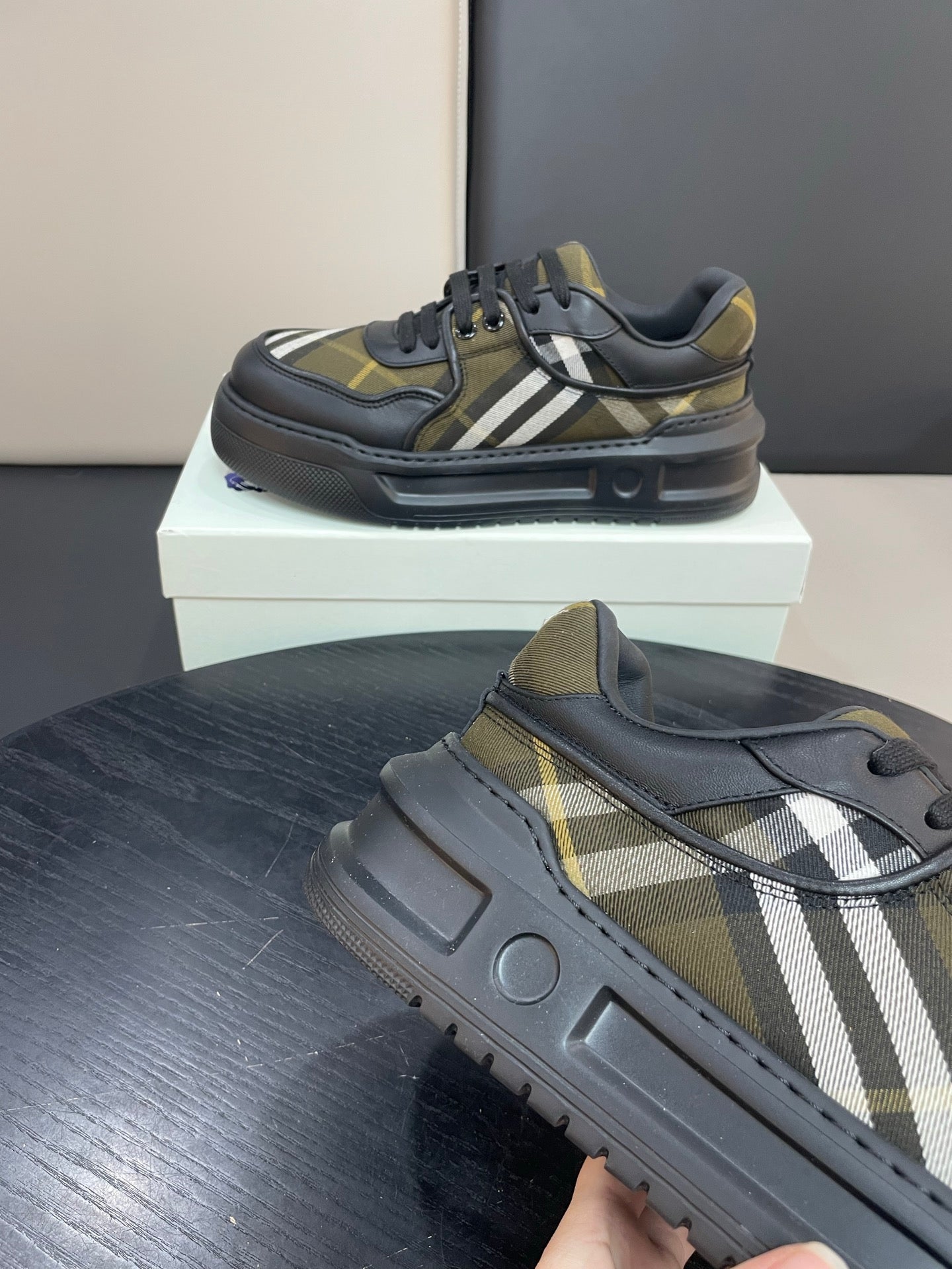 Burberry sneakers on shoe box, black uppers with yellow plaid and white stripe