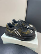 Burberry low-top sneakers on box, black uppers with yellow plaid and white stripe
