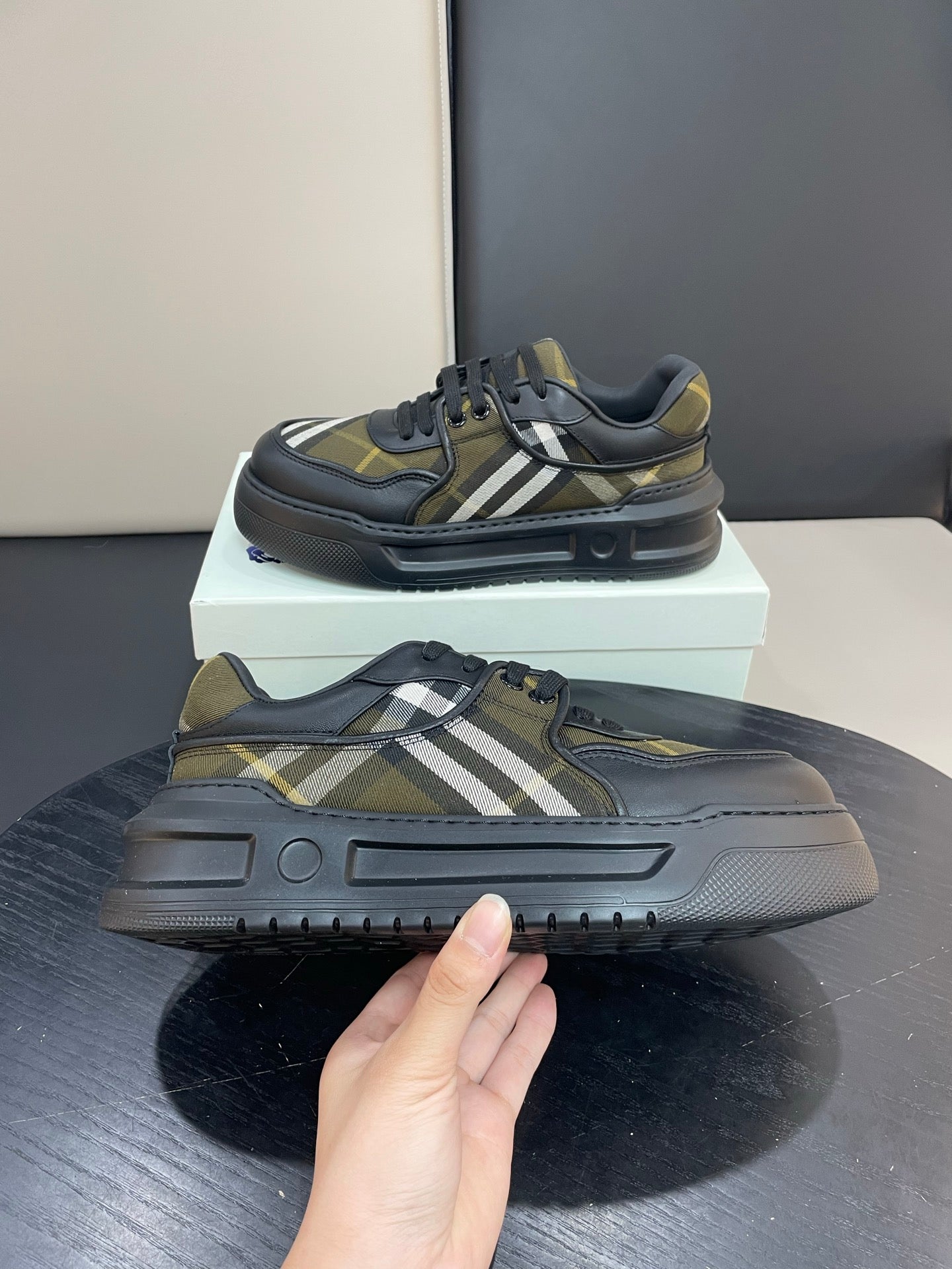 Burberry sneakers front and sole view together, black with yellow plaid stripe