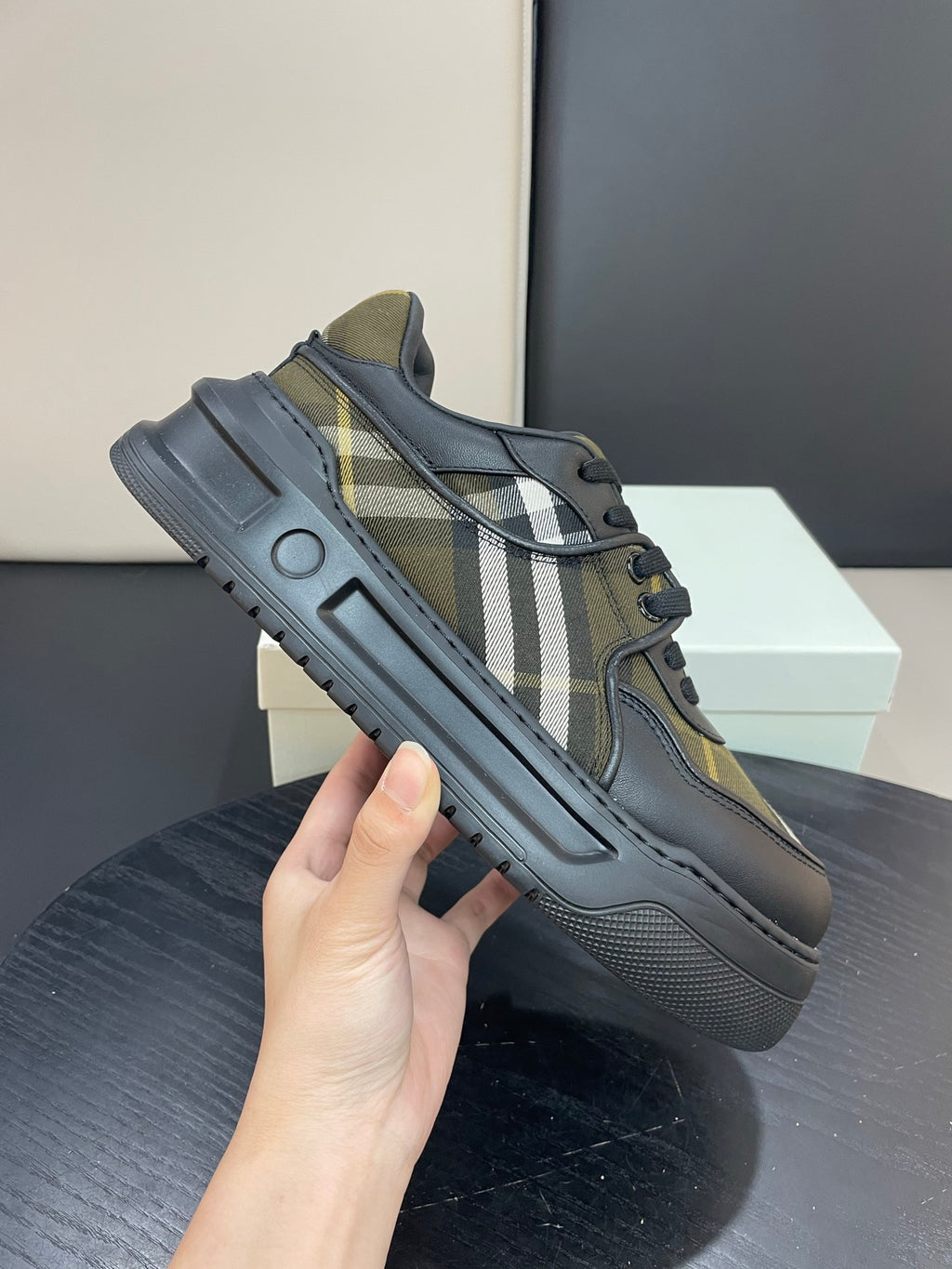 Burberry low-top sneakers with black leather and plaid stripe panels, lace-up design