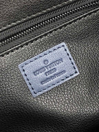 Louis Vuitton bag leather tag patch with Louis Vuitton and Paris imprint on dark blue surface
