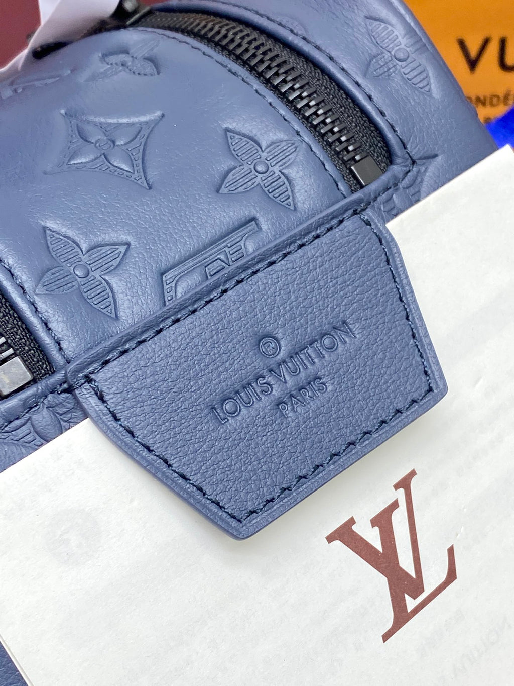 Louis Vuitton bag pocket panel with embossed monogram motifs and leather corner tab