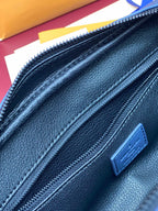 Louis Vuitton bag zipper detail with blue leather pull tab on textured dark blue finish
