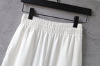 White pants with elastic waistband and gathered front, top view
