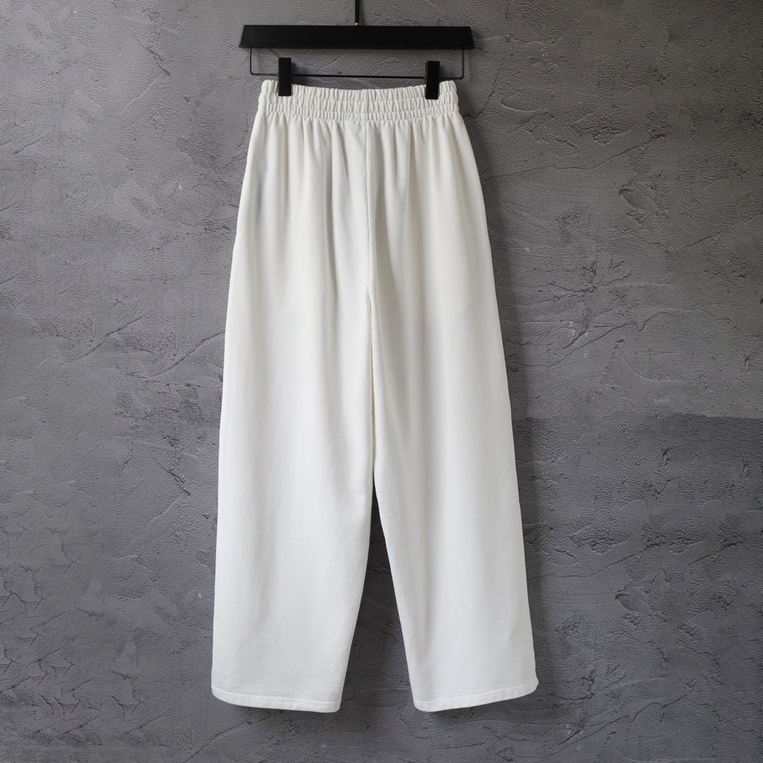 White wide-leg pants with gathered elastic waistband and straight wide fit