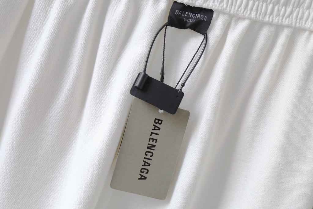 White pants with Balenciaga hang tag attached near elastic waistband