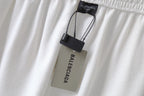White pants with Balenciaga hang tag attached to elastic waistband