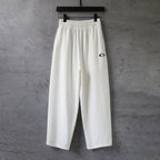 White wide-leg pants with elastic waistband and drawstring, front view